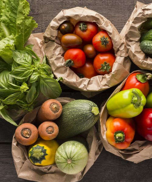 Close up of fresh eco vegetables in coton bags on wood